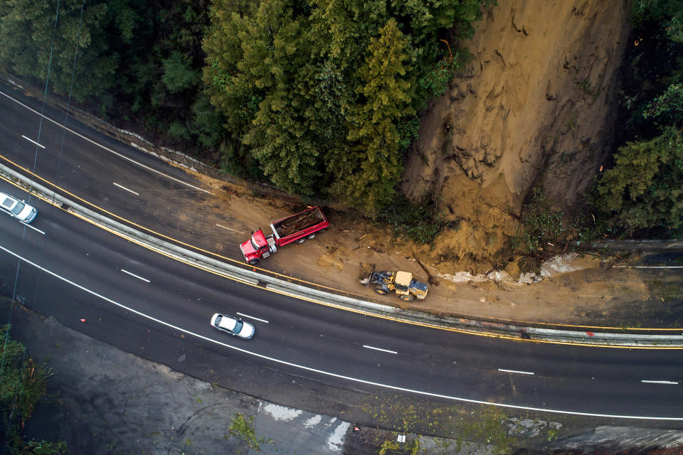 Caltrans crews work to clear a mudslide on Highway 17 that resulted from heavy rain on Jan. 9, 2023, in the Santa Cruz Mountains, south of Glenwood Drive in Scott's Valley, California.