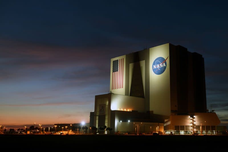 NASA's Vehicle Assembly Building stands at dusk at the Kennedy Space Center in Florida in August. NASA announced Tuesday it will delay its Artemis launches to "work through challenges." File Photo by Joe Marino/UPI