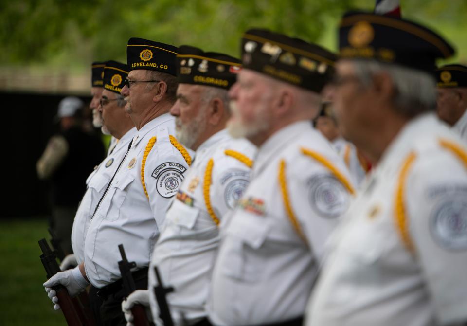 Members of the honor guard of the Associated Veterans of Loveland stand at attention ahead of a rifle volley during the Memorial Day events at Veterans Plaza at Spring Canyon Community Park in Fort Collins in May 2021. Coloradoan file photo