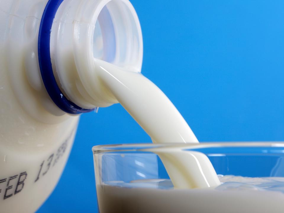 Close-up of cow&#39;s milk being poured into a glass.