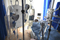 FILE - In this May 5, 2020 file photo a patient with coronavirus is treated in the intensive care unit at the Royal Papworth Hospital in Cambridge, England. (Neil Hall/Pool via AP, File)