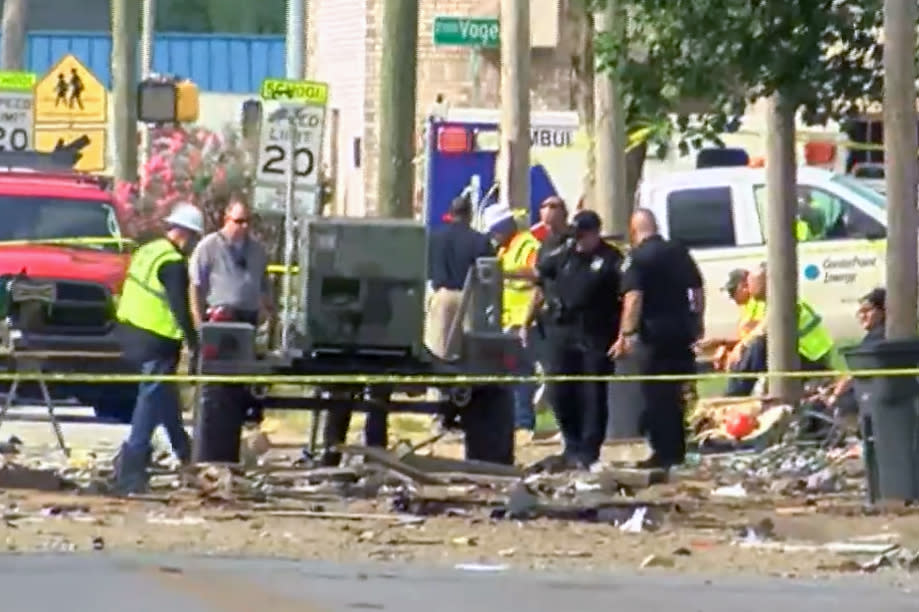 Emergency personnel investigate a house explosion Wednesday in Evansville, Ind. (WFIE)