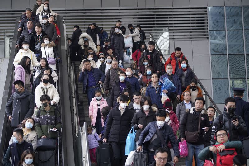 Passengers wearing masks are seen at Shanghai railway station in Shanghai