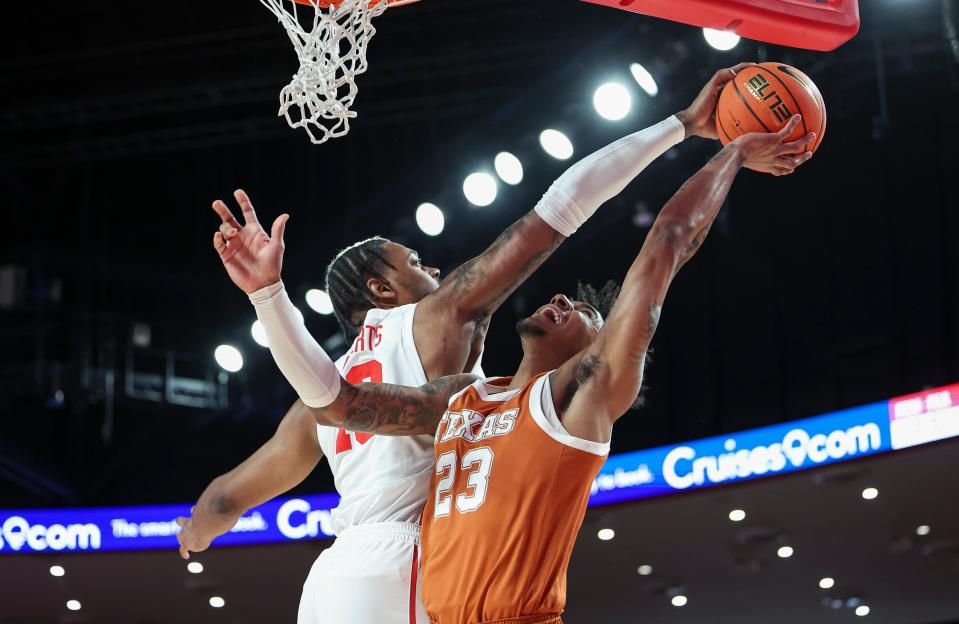 Houston's J'Wan Roberts blocks a shot by Texas' Dillon Mitchell in the Cougars' 82-61 victory Saturday at the Fertitta Center. The Longhorns fell to 16-9 overall and 5-7 in the Big 12, and their NCAA Tournament hopes are in jeopardy.