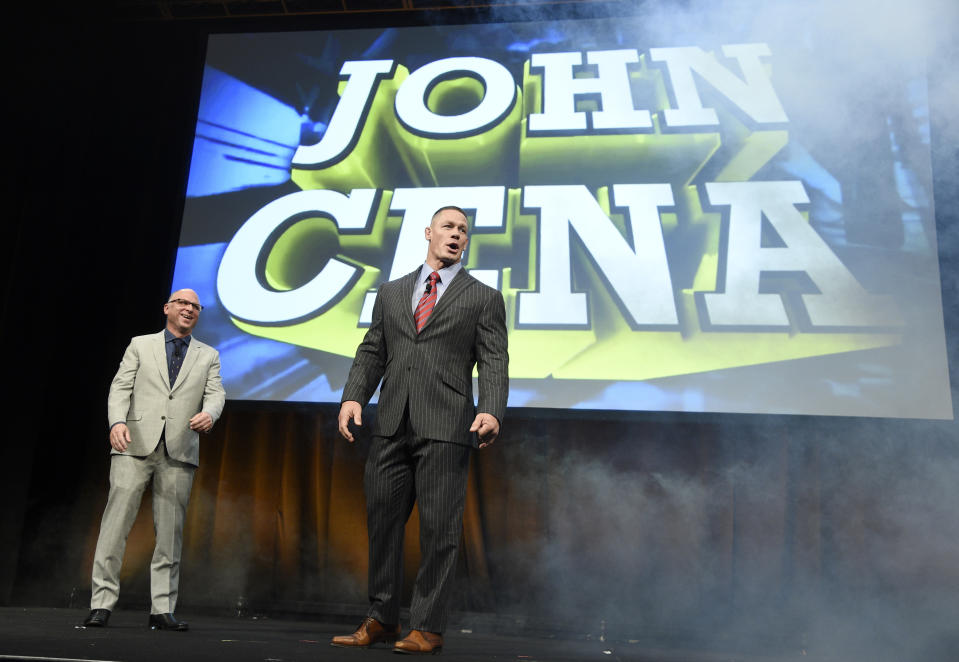 John Cena, right, a cast member in the upcoming film "The Wall," arrives onstage as Bob Berney, head of distribution and marketing for Amazon Studios, looks on during the Amazon Studios presentation at CinemaCon 2017 at Caesars Palace on Thursday, March 30, 2017, in Las Vegas. (Photo by Chris Pizzello/Invision/AP)