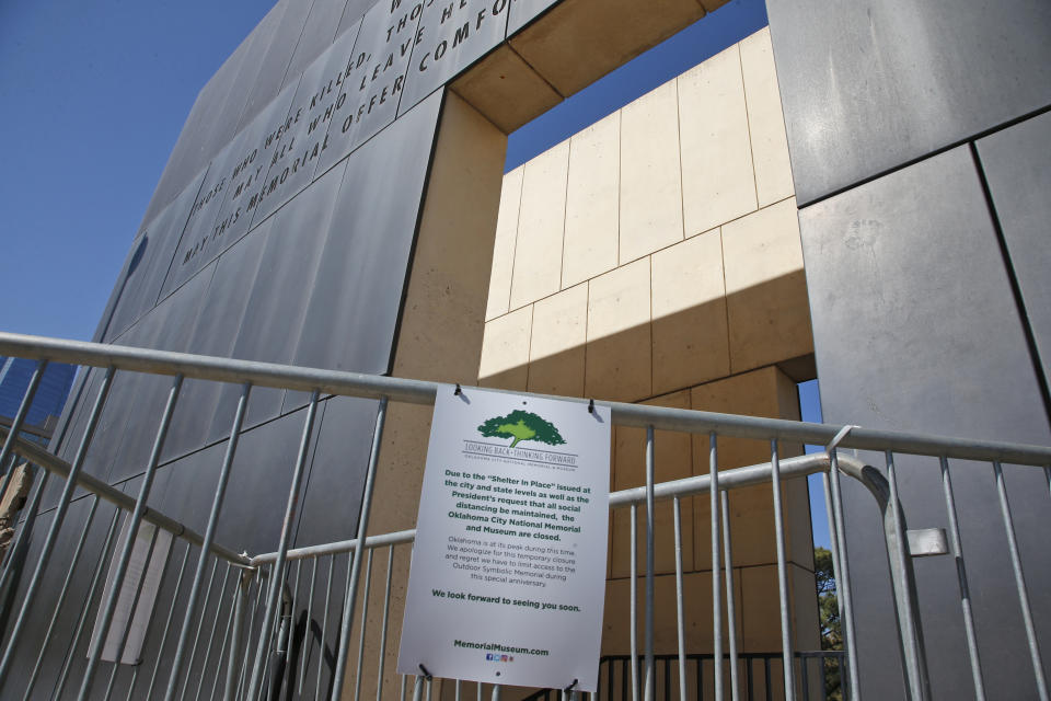 A gate leading to the Oklahoma City National Memorial and Museum is pictured behind a "closed" sign Wednesday, April 15, 2020, in Oklahoma City. Due to COVID-19 concerns, the museum scaled back its plans for a 25th anniversary remembrance and will instead offer a recorded, one-hour television program that includes the reading of the names of the 168 people killed in the bombing followed by 168 seconds of silence, instead of the annual open-to-the-public ceremony. (AP Photo/Sue Ogrocki)