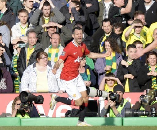 Manchester United's Ryan Giggs (C) celebrates acfter scoring the winning goal during the Premier League match against Norwich City February 26. Giggs' goal in the second minute of stoppage time earned United a 2-1 win at Norwich City on Sunday