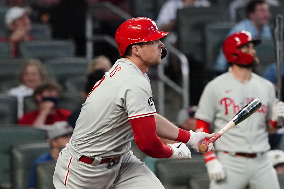 Philadelphia Phillies' Rhys Hoskins (17) hits a solo home run in the fourth inning of a baseball game against the Atlanta Braves Sunday, April 11, 2021, in Atlanta. (AP Photo/John Bazemore)