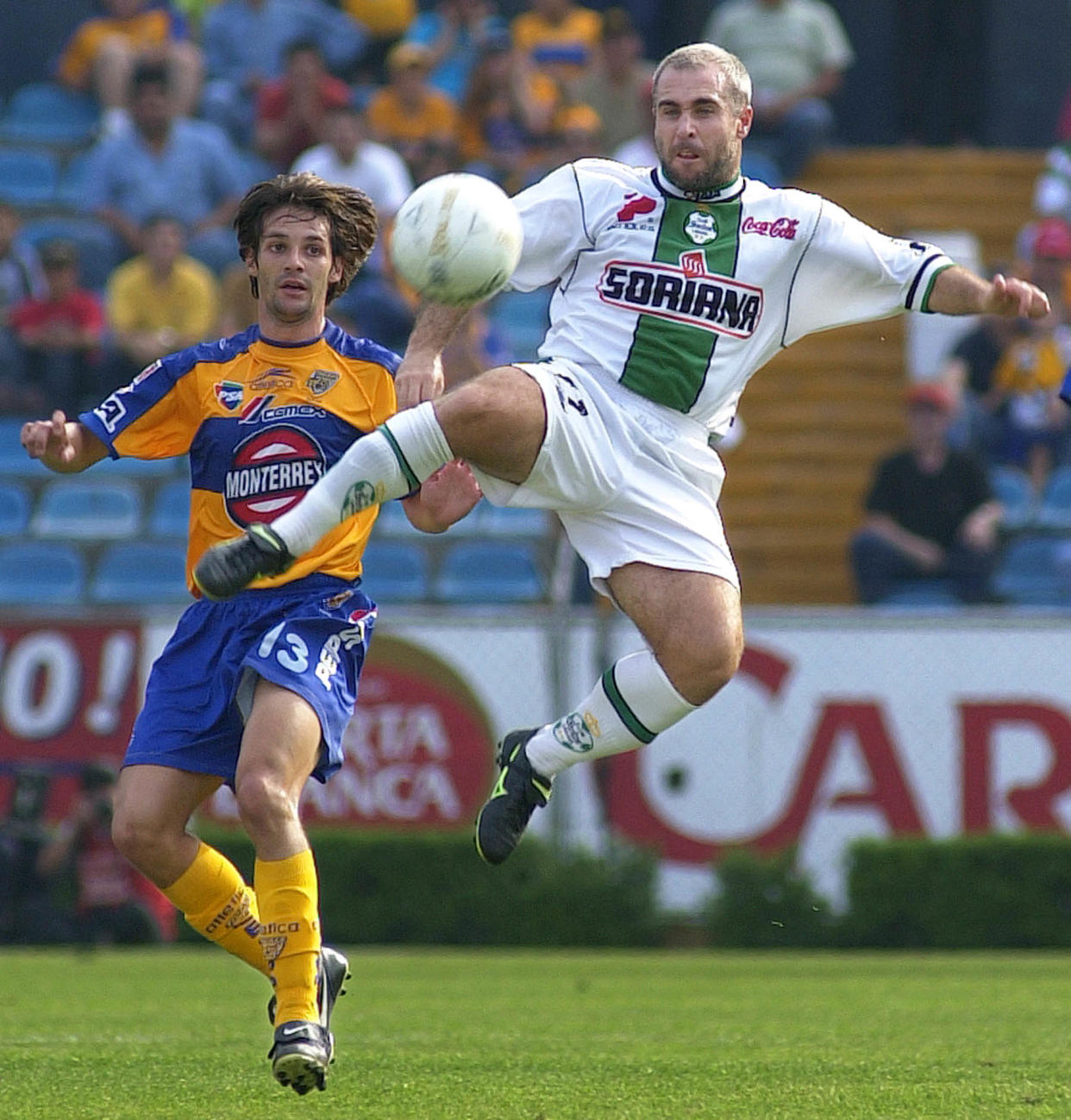 Santos' Rodrigo Ruiz, right, battles Tigres' Jorge Santillana during their match in Monterrey, Mexico, Saturday, April 20, 2002. (AP Photo/Gregory Bull)