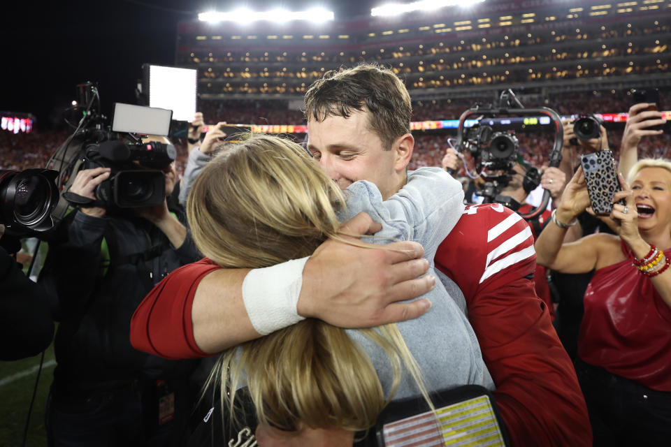 SANTA CLARA, CALIFORNIA - JANUARY 28: Brock Purdy #13 of the San Francisco 49ers hugs girlfriend Jenna Brandt after defeatng the Detroit Lions 34-31 in the NFC Championship Game at Levi's Stadium on January 28, 2024 in Santa Clara, California. (Photo by Ezra Shaw/Getty Images)