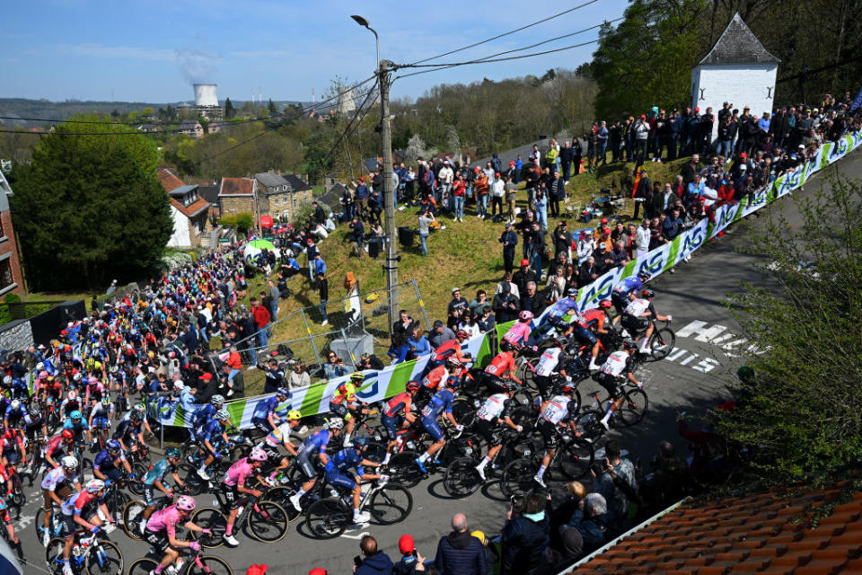 HUY BELGIUM  APRIL 19 A general view of the peloton climbing to the Cte de Cherav 195m while fans cheer during the 87th La Fleche Wallonne 2023 Mens Elite a 1943km one day race from Herve to Mur de Huy  UCIWT  on April 19 2023 in Huy Belgium Photo by Luc ClaessenGetty Images