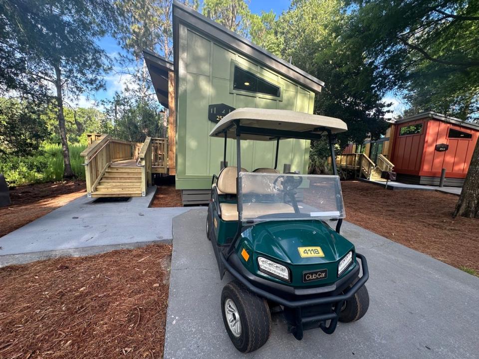 Golf cart parked outside of cabin 