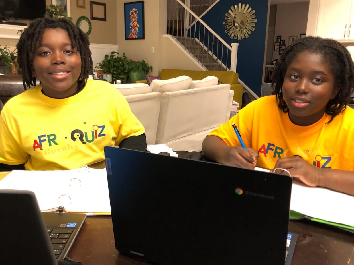 Samson Vanderpuye, left, and his older brother Isaiah Vanderpuye study for the 2024 edition of AfroQuiz, a long-running Jeopardy!-style competition hosted by the Council for Canadians of African and Caribbean Heritage.   (Submitted by Salome Asea - image credit)