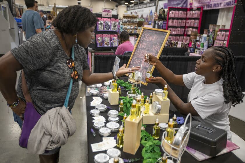 Lancaster, CA - September 23: Ashakia Morgan, 26, of Lancaster working at her Morgans Naturals booth at The Antelope Valley Fair on Friday, Sept. 23, 2022, in Lancaster, CA. Multiple voters in the CA-27 congressional district (northern Los Angeles county, primary in Palmdale and Lancaster) have been interviewed about how the Jan. 6 attack on the Capitol and the state of American democracy is or is not factoring into their vote in November. The district is one of the most competitive races in the country, pitting GOP Rep. Mike Garcia against challenger Christy Smith, a Democrat. (Francine Orr / Los Angeles Times)