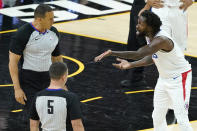 Los Angeles Clippers guard Patrick Beverley, right, shows officials blood on his hand as he reacts after being called for a foul on Phoenix Suns guard Devin Booker during the second half of Game 2 of the NBA basketball Western Conference Finals, Tuesday, June 22, 2021, in Phoenix. (AP Photo/Matt York)