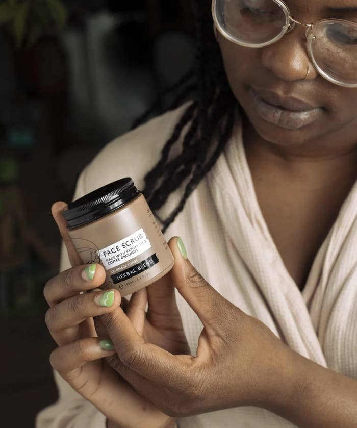 a person holding the face scrub