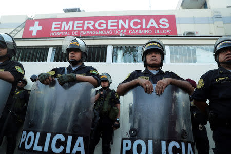 Police stand guard outside a hospital where Peru's former President Alan Garcia was taken after he shot himself, in Lima, Peru April 17, 2019. REUTERS/Guadalupe Pardo