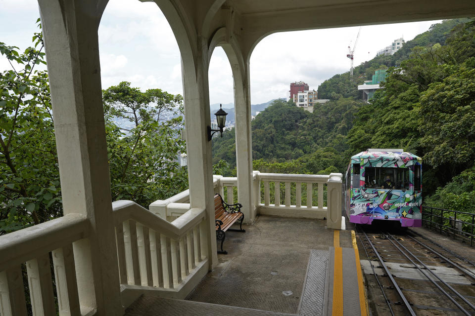 A Peak Tram passes an uphill of the Victoria Peak in Hong Kong on June 17, 2021. Hong Kong’s Peak Tram is a fixture in the memories of many residents and tourists, ferrying passengers up Victoria Peak for a bird’s eye view of the city’s many skyscrapers. (AP Photo/Vincent Yu)