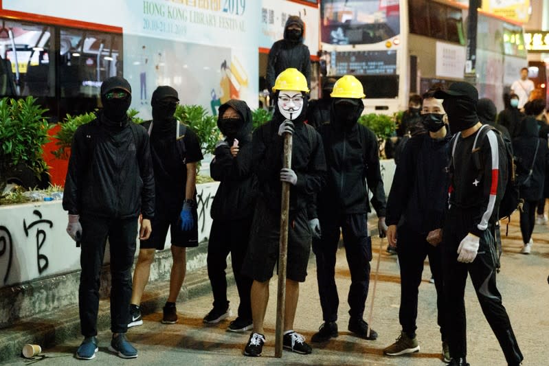 Protesters stand in Nathan Road before facing off with police during a protest in Mong Kok in Hong Kong