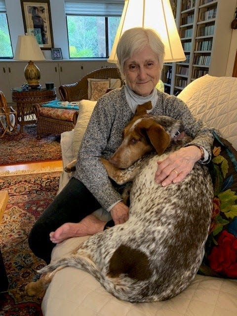 Riley snuggles with her owner Marian Reid.