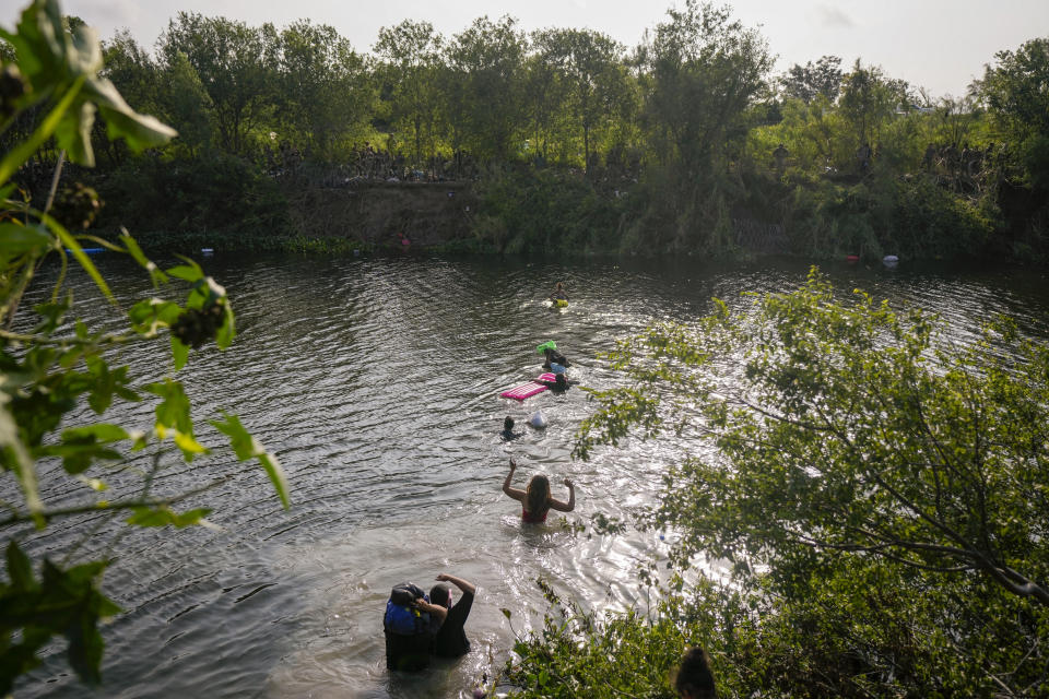 Migrants cross the Rio Grande river into the U.S., seen from Matamoros, Mexico, Wednesday, May 10, 2023. Asylum seekers have been showing up at the US-Mexico border in huge numbers in anticipation of the restriction of Title 42, that had allowed the government to quickly expel migrants to Mexico. New measures were announced Wednesday creating new legal pathways for migrants. (AP Photo/Fernando Llano)