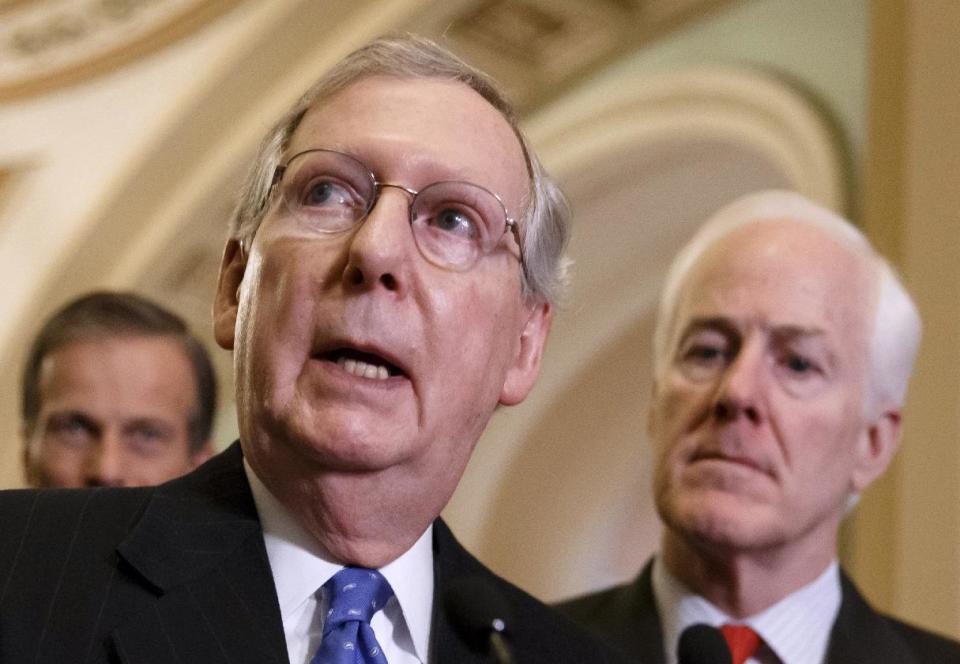 FILE - This March 25, 2014 file photo shows Senate Minority Leader Mitch McConnell of Ky., center, speaking to reporters on Capitol Hill in Washington. Republicans in the 2014 midterm elections can’t seem to reach an official party line on that the old Washington practice of writing the federal budget to benefit the folks back home. Sure, top Republicans like McConnell _ now Senate minority leader _ and former Senate Appropriations Chairman Thad Cochran of Mississippi begrudgingly banned so-called earmarks more than three years ago. They were reacting both to the tea party’s rise and a push from conservative House Republicans like Georgia Rep. Jack Kingston, now a House Appropriations subcommittee chairman. McConnell is accompanied by Sen. John Thune, R-S.D., left, and Senate Minority Whip John Cornyn of Texas. (AP Photo/J. Scott Applewhite, File)