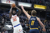 New York Knicks' Julius Randle (30) shoots over Indiana Pacers' Domantas Sabonis (11) during the first half of an NBA basketball game Wednesday, Dec. 8, 2021, in Indianapolis. (AP Photo/Darron Cummings)