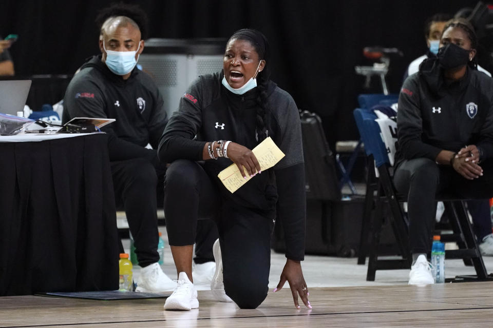 FILE - Old Dominion head coach DeLisha Milton-Jones watches from the bench during the first half of an NCAA college basketball game against Rice in the Conference USA women's tournament, Friday, March 12, 2021, in Frisco, Texas. Milton-Jones was one of the first WNBA marquee American players to play in Russia in the early 2000s. The former All-American at Florida, WNBA All-Star and two-time WNBA champion with the Los Angeles Sparks said the decision to play in Russia was simply a “business one.” (AP Photo/Tony Gutierrez, File)