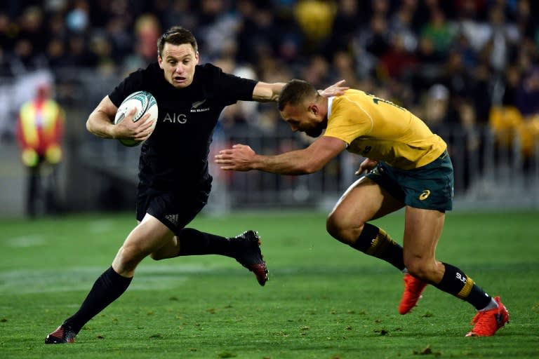 New Zealand's Ben Smith (left) is tackled by Australia's Quade Cooper during the rugby Test match between New Zealand and Australia at Westpac Stadium in Wellington on August 27, 2016