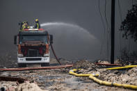 Firefighters work to put out a deadly fire at a large oil storage facility in Matanzas, Cuba, Tuesday, Aug. 9, 2022. The fire was triggered when lighting struck one of the facility's eight tanks late Friday, Aug. 5th. (Yamil Lage, Pool photo via AP)