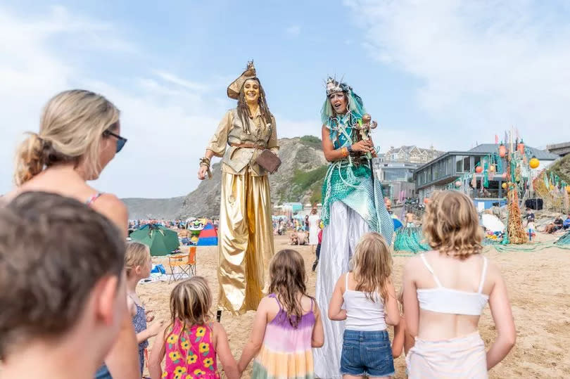 Roaming stilt walkers at Arts on the Beach