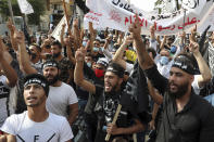 Protesters chant slogans as they wear headbands with Arabic that read: "We are your soldiers, Oh Muhammad," during a protest against French President Macron's comments over Prophet Muhammad caricatures, near the Pine Palace, which is the residence of the French ambassador, in Beirut, Lebanon, Friday, Oct. 30, 2020. Thousands of Muslims, from Pakistan to Lebanon to the Palestinian territories, poured out of prayer services to join anti-France protests on Friday, as the French president's vow to protect the right to caricature the Prophet Muhammad continues to roil the Muslim world. (AP Photo/Bilal Hussein)