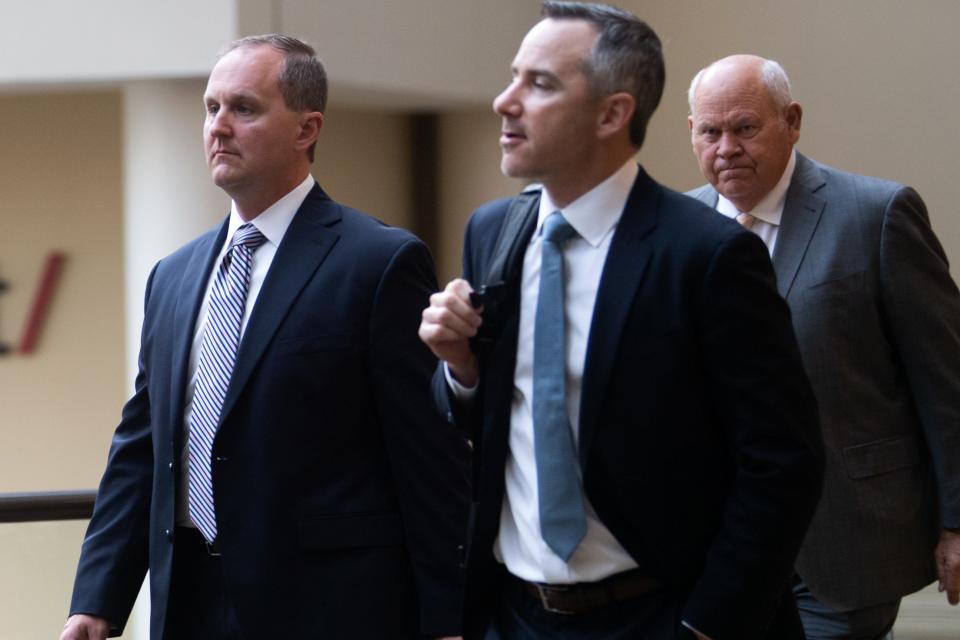 University of Tennessee chief of staff Matthew Scoggins, left, and attorney Michael Sheridan walk ahead of former UT athletics director Phillip Fulmer to the ballroom for an NCAA infractions hearing at the Westin Cincinnati in Cincinnati on Wednesday, April 19, 2023.