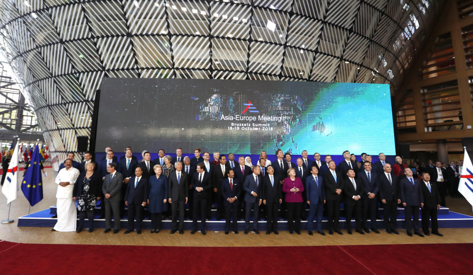 European Union leaders and their Asian counterparts pose for a group photo during an EU-ASEM summit in Brussels, Friday, Oct. 19, 2018. EU leaders met with their Asian counterparts Friday to discuss trade, among other issues. (AP Photo/Alastair Grant)