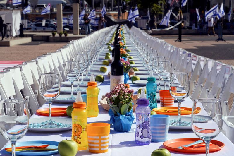 FILE PHOTO: A dinner table is set with empty chairs that symbolically represent hostages and missing people with families that are waiting for them to come home, following a deadly infiltration by Hamas gunmen from the Gaza Strip, in Tel Aviv
