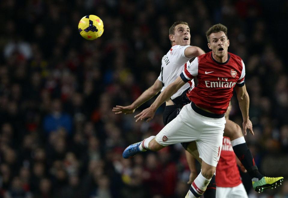 Arsenal's Aaron Ramsey challenges Liverpool's Jordan Henderson during their English Premier League soccer match in London