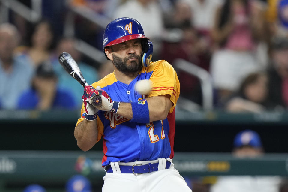 FILE - Venezuela's Jose Altuve is hit by a pitch during the fifth inning of a World Baseball Classic game against the U.S., March 18, 2023, in Miami. Even with Jose Altuve injured and three-time Cy Young Award winner Justin Verlander gone in free agency, Houston is a solid favorite to win another division title, according to FanDuel Sportsbook. (AP Photo/Wilfredo Lee, File)