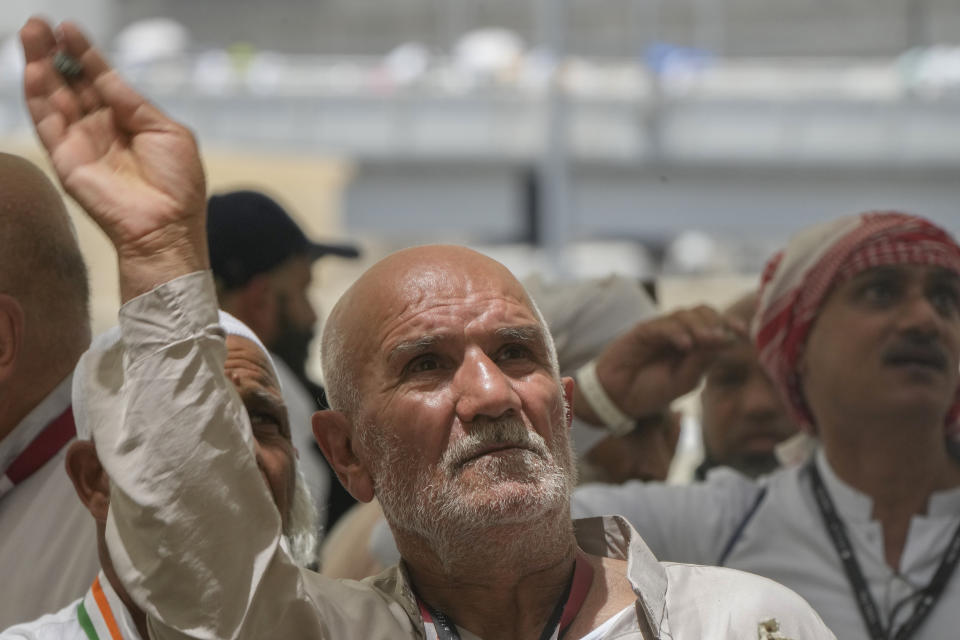 An Iranian pilgrim casts a stone at a pillar in the symbolic stoning of the devil, the last rite of the annual Hajj pilgrimage, in Mina near the holly city of Mecca, Saudi Arabia, Thursday, June 29, 2023. (AP Photo/Amr Nabil)