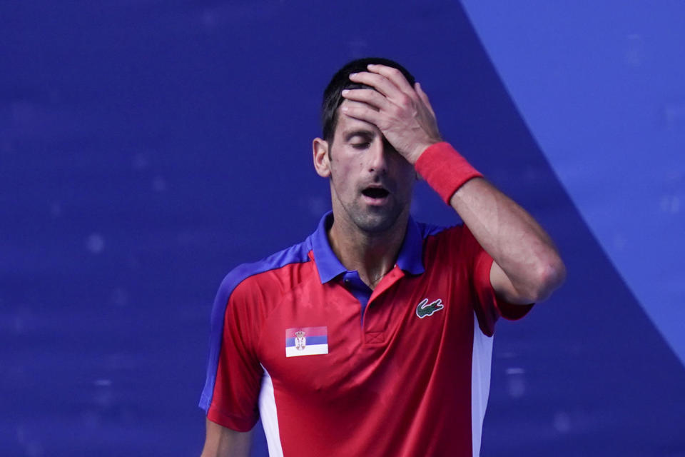 Novak Djokovic, of Serbia, reacts during the bronze medal match of the tennis competition against Pablo Carreno Busta, of Spain, at the 2020 Summer Olympics, Saturday, July 31, 2021, in Tokyo, Japan. / Credit: Seth Wenig / AP