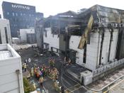 Firefighters carry a body at the site of a fire at a lithium battery manufacturing factory in Hwaseong, South Korea, Monday, June 24, 2024. (Newsis via AP)