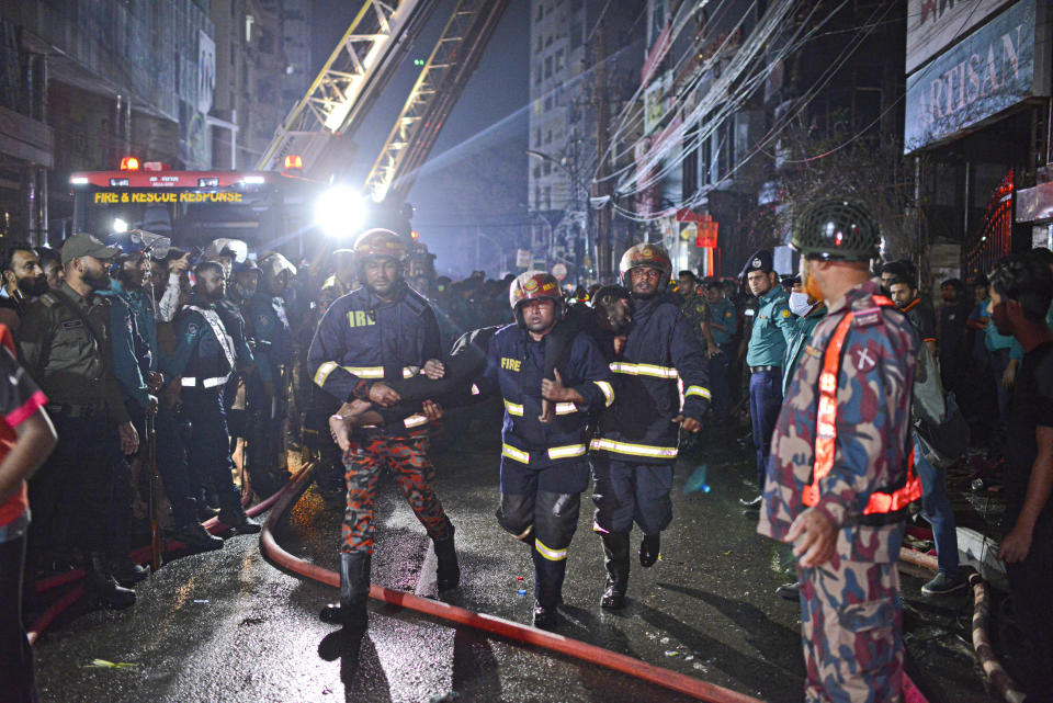 Firefighters work to contain a fire that broke out at a commercial complex in Dhaka, Bangladesh, Friday, March 1, 2024. Bangladesh's health minister says a fire in a six-story commercial complex in the nation's capital, Dhaka, has killed several people and injured dozens of others. (AP Photo/Mahmud Hossain Opu)