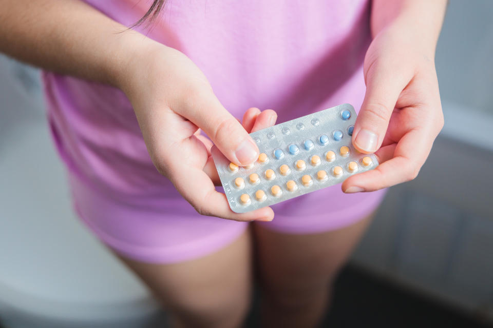 Person holding a pack of birth control pills