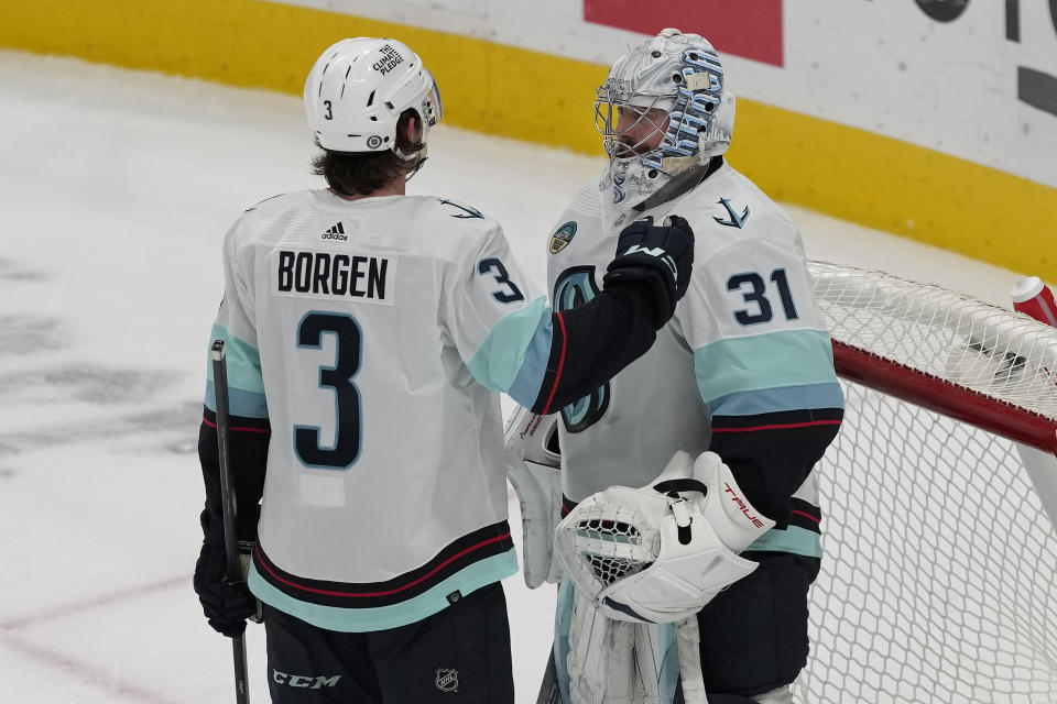 Seattle Kraken defenseman Will Borgen (3) celebrates with goaltender Philipp Grubauer (31) after the Kraken defeated the San Jose Sharks in an NHL hockey game in San Jose, Calif., Monday, April 1, 2024. (AP Photo/Jeff Chiu)