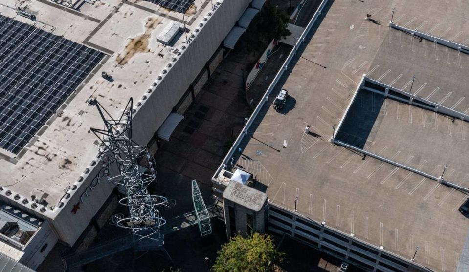 A pop-up tent stands Tuesday where ere a man who barricaded himself atop a downtown Sacramento parking garage was fatally shot by police during a standoff. The incident began just after 1 a.m. when the man was reported in the Downtown Plaza West parking garage at Third and L streets with a weapon.