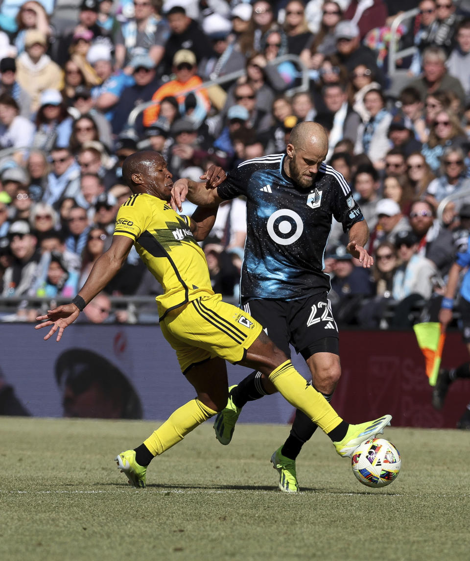 Columbus Crew midfielder Darlington Nagbe (6) and Minnesota United forward Teemu Pukki (22) go after the ball during the first half of an MLS soccer match, Saturday, March 2, 2024, in St. Paul, Minn. (AP Photo/Stacy Bengs)