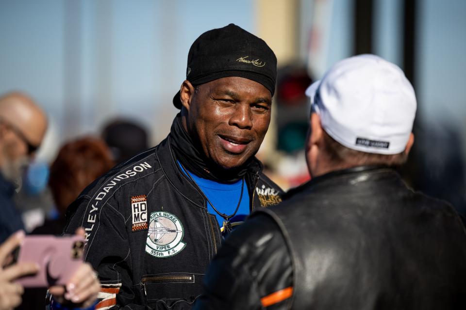 Former NFL football player and U.S. Senate candidate Herschel Walker talks with people during a stop of the Kyle Petty Charity Ride at Manheim Utah in Woods Cross on Saturday, April 29, 2023. | Spenser Heaps, Deseret News