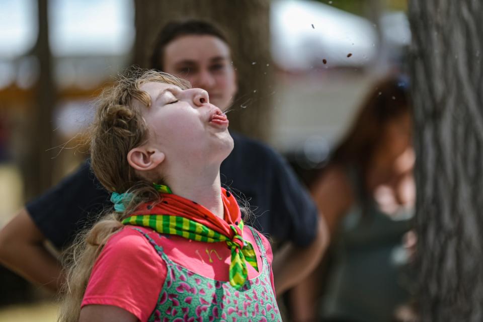 Yohannah Rabe competes in seed spitting at the 2022 Rush Springs Watermelon Festival.