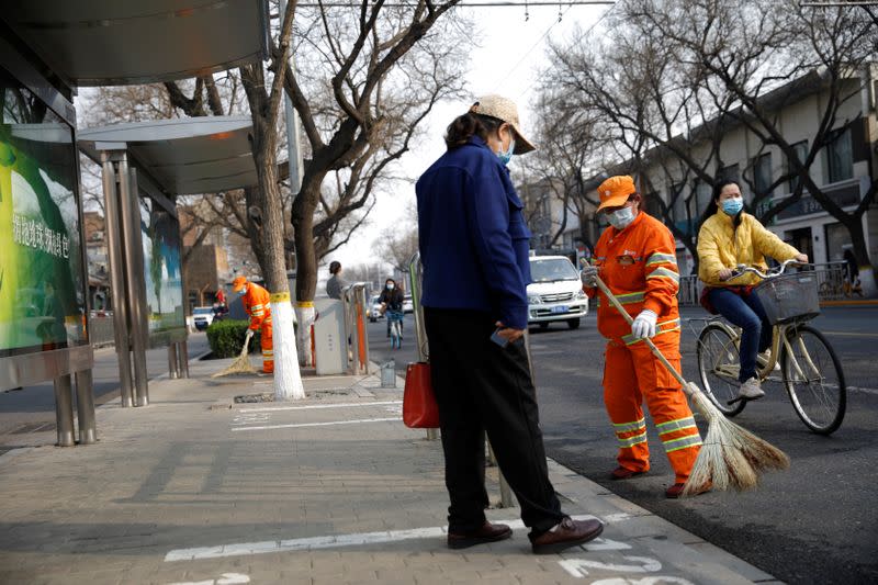 People wearing face masks on a street following an outbreak of the coronavirus disease (COVID-19), in Beijing, China