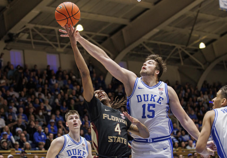 Florida State's Caleb Mills (4) attempts a shot ahead of Duke's Ryan Young (15) during the first half of an NCAA college basketball game in Durham, N.C., Saturday, Dec. 31, 2022. (AP Photo/Ben McKeown)