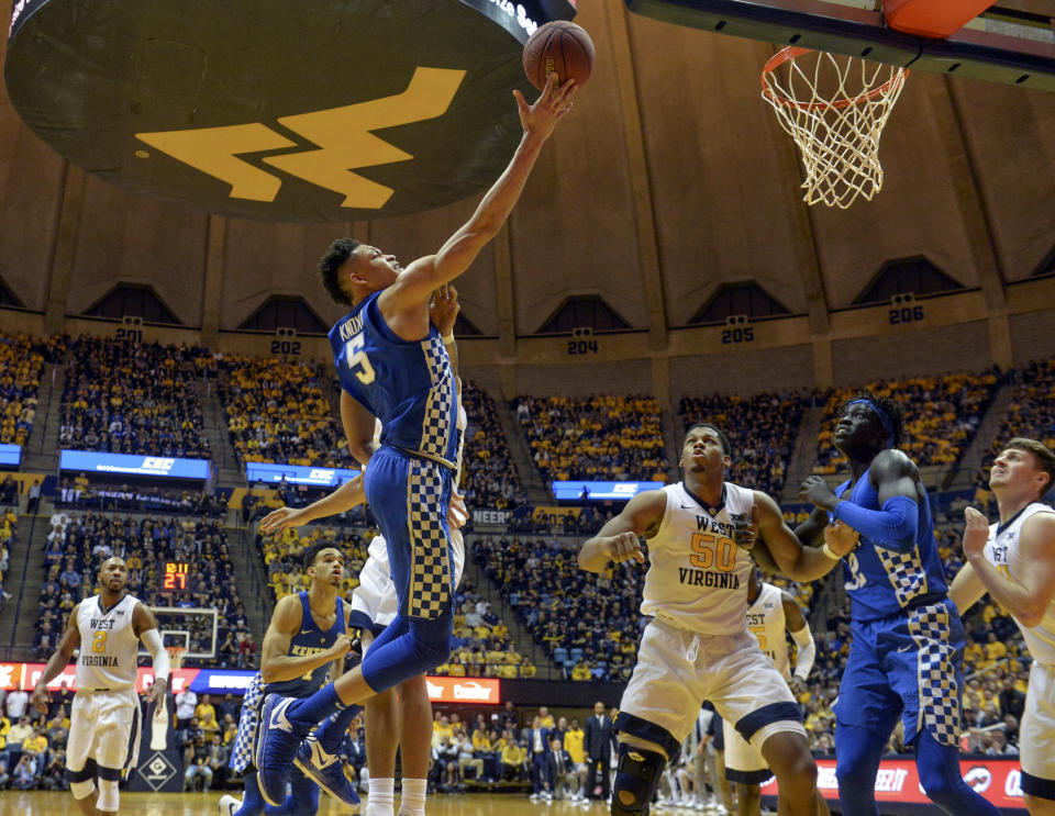 Kentucky forward Kevin Knox attempts a layup over West Virginia forward Sagaba Konate during the second half of an NCAA college basketball game Saturday, Jan. 27, 2018, in Morgantown, W.Va. (William Wotring/The Dominion-Post via AP)